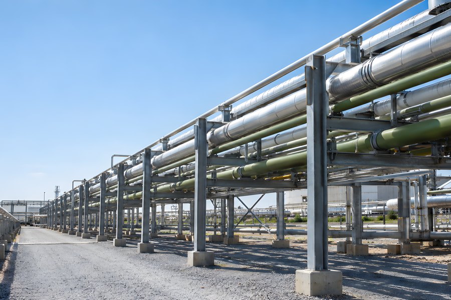 Industrial Pipe Rack Corridor with Insulated Steel Pipelines at a Processing Plant