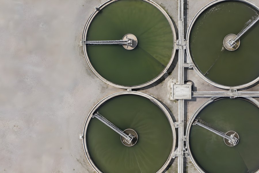 Aerial View of Four Circular Clarifier Tanks at a Water Treatment Plant with Rotating Rake Arms