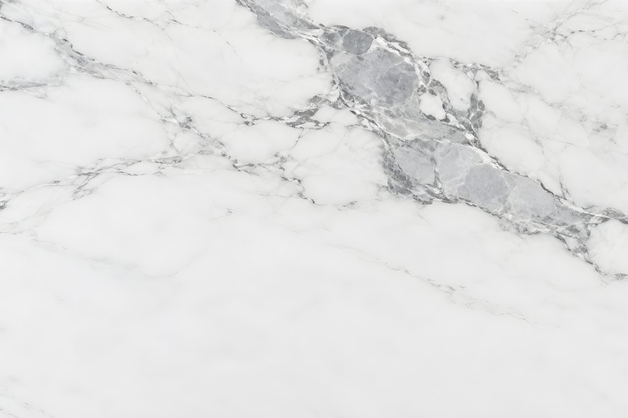 Polished white marble slab surface with diagonal grey veining, natural stone texture background