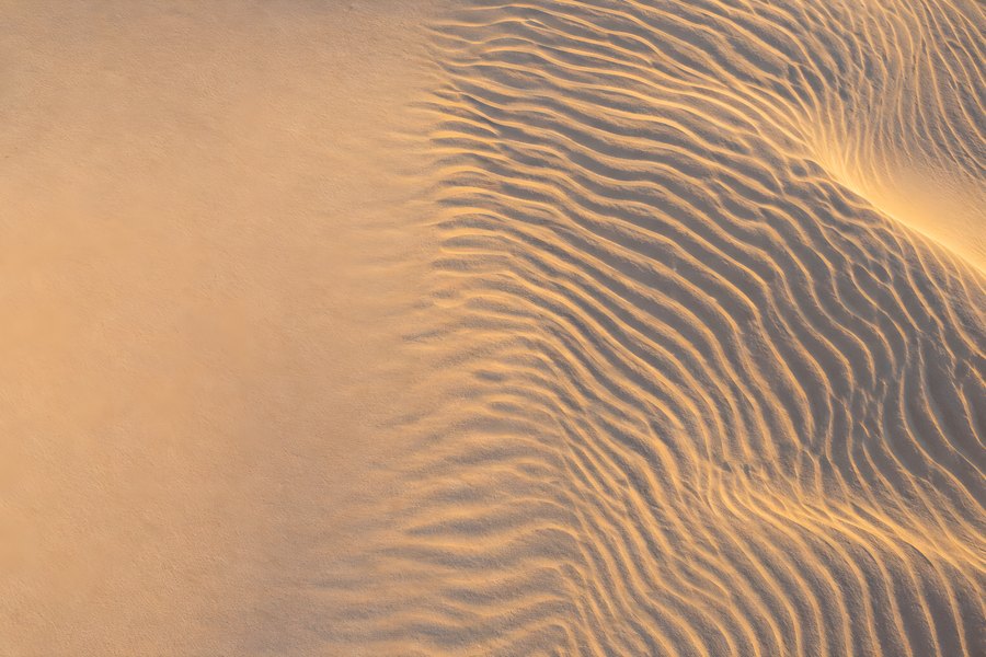 Golden Sand Dune with Wind-Rippled Texture, Aerial Top-Down View of Smooth and Rippled Desert Sand