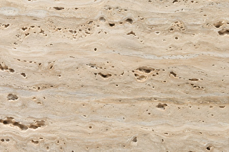 Honed travertine stone texture with natural pores and soft linear veining, warm beige natural stone surface for luxury backgrounds